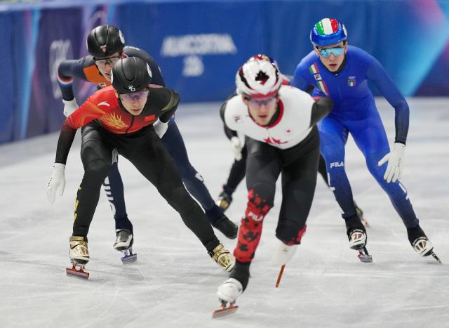 (260213) -- MILAN, Feb. 13, 2026 (Xinhua) -- Liu Shaoang (L, front) of China competes during the short track speed skating men's 1000m quarterfinal at the Milan-Cortina 2026 Olympic Winter Games in Milan, Italy, Feb. 12, 2026. (Xinhua/Xue Yuge)