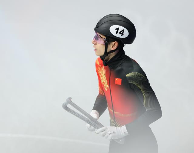 (260213) -- MILAN, Feb. 13, 2026 (Xinhua) -- Liu Shaoang of China reacts after the short track speed skating men's 1000m quarterfinal at the Milan-Cortina 2026 Olympic Winter Games in Milan, Italy, Feb. 12, 2026. (Xinhua/Li Ming)
