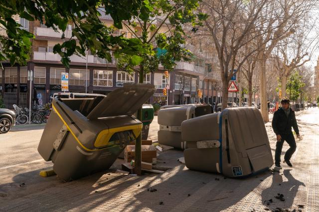 (260213) -- BARCELONA, Feb. 13, 2026 (Xinhua) -- Garbage containers lie overturned due to strong winds in Barcelona, Spain, on Feb. 12, 2026.
  Winds gusting at over 100 kilometers per hour have caused injuries, structural damage and transport disruptions in the northeastern Spanish region of Catalonia.
  The strong winds, brought by Storm Nils, are the latest in a series of extreme weather events affecting Spain since the beginning of the year. Catalonia was placed on red alert, with schools and colleges closed as a precaution.
  By midday Thursday, nearly 100 flights had been canceled at Barcelona's El Prat Airport, while dozens of incoming flights were diverted to other airports. (Photo by Joan Gosa/Xinhua)