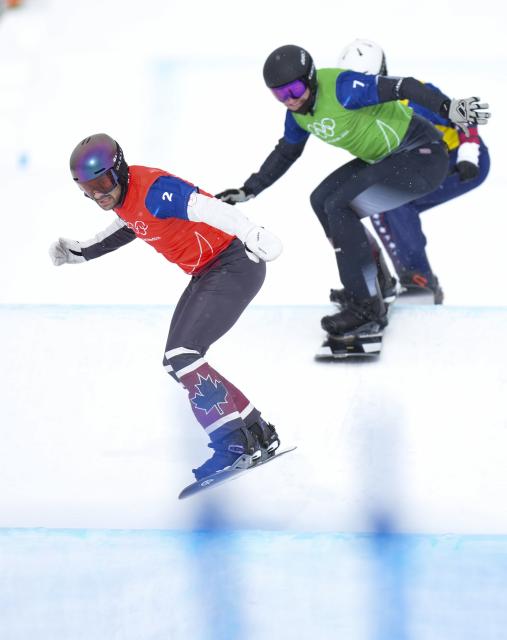 (260213) -- LIVIGNO, Feb. 13, 2026 (Xinhua) -- Eliot Grondin (front) of Canada competes during the snowboard men's cross quarterfinal at the Milan-Cortina 2026 Olympic Winter Games in Livigno, Italy, Feb. 12, 2026. (Xinhua/Xia Yifang)