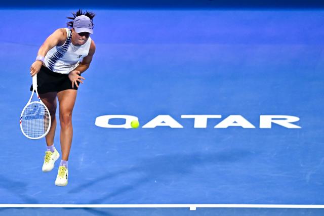 (260213) -- DOHA, Feb. 13, 2026 (Xinhua) -- Iga Swiatek serves during the women's singles quarterfinal match between Iga Swiatek of Poland and Maria Sakkari of Greece at the WTA Qatar Open 2026 tennis tournament in Doha, Qatar, on Feb. 12, 2026. (Photo by Nikku/Xinhua)