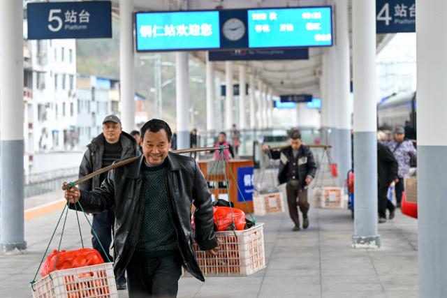 (260213) -- TONGREN, Feb. 13, 2026 (Xinhua) -- A farmer from Hunan Province carrying goods for sale prepare to leave the Tongren Railway Station in Tongren City, southwest China's Guizhou Province, Feb. 12, 2026.
  The train No. 7272/7271 has run across the mountainous areas in Hunan, Guizhou and Chongqing for almost 20 years. With an average speed of just 40 kilometers per hour, the train has made it easier for residents along the route to travel and commute, while also helping local products reach wider markets. (Photo by Yuan Fuhong/Xinhua)