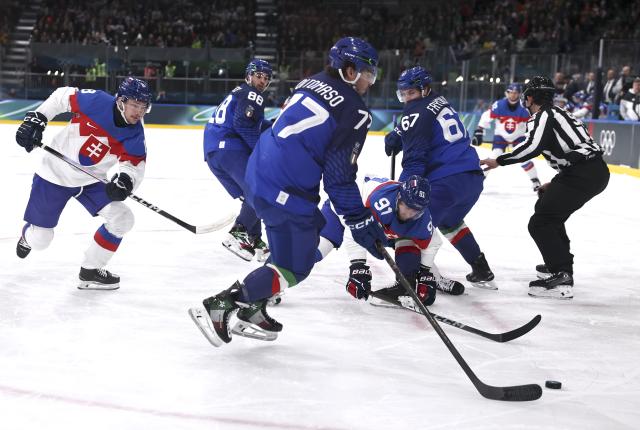 (260213) -- MILAN, Feb. 13, 2026 (Xinhua) -- Matus Sukel (C) of Slovakia competes against Gregory di Tomaso (3rd L) of Italy during the ice hockey men's preliminary round group B match between Italy and Slovakia at the Milan-Cortina 2026 Olympic Winter Games in Milan, Italy, Feb. 13, 2026. (Xinhua/Wang Kaiyan)