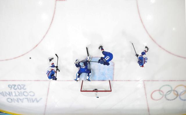 (260213) -- MILAN, Feb. 13, 2026 (Xinhua) -- Players of both teams compete during the ice hockey men's preliminary round group B match between Italy and Slovakia at the Milan-Cortina 2026 Olympic Winter Games in Milan, Italy, Feb. 13, 2026. (Xinhua/Wang Kaiyan)