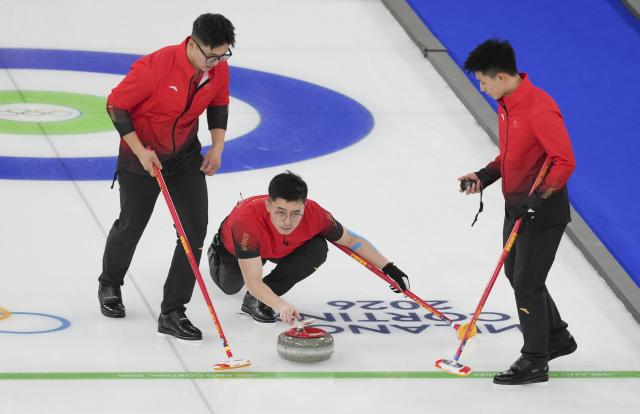(260213) -- CORTINA D'AMPEZZO, Feb. 13, 2026 (Xinhua) -- Li Zhichao, Xu Jingtao and Fei Xueqing (from L to R) of China compete during the curling men round robin session 3 match between China and Norway at the Milan-Cortina 2026 Olympic Winter Games in Cortina, Italy, Feb. 13, 2026. (Xinhua/Li Gang)