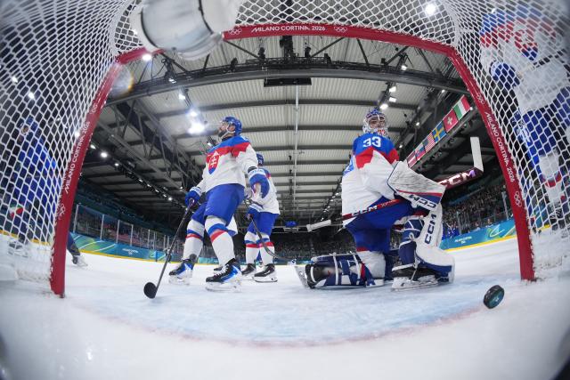 (260213) -- MILAN, Feb. 13, 2026 (Xinhua) -- Stanislav Skorvanek (R), goalkeeper of Slovakia, fails to make a save during the ice hockey men's preliminary round group B match between Italy and Slovakia at the Milan-Cortina 2026 Olympic Winter Games in Milan, Italy, Feb. 13, 2026. (Wang Kaiyan/Pool via Xinhua)