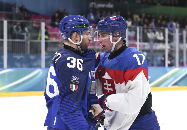 (260213) -- MILAN, Feb. 13, 2026 (Xinhua) -- Cristiano Digiacinto (L) of Italy fights with Simon Nemec of Slovakia during the ice hockey men's preliminary round group B match between Italy and Slovakia at the Milan-Cortina 2026 Olympic Winter Games in Milan, Italy, Feb. 13, 2026. (Xinhua/Wang Kaiyan)