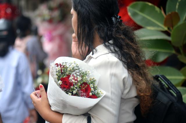 (260213) -- COLOMBO, Feb. 13, 2026 (Xinhua) -- A woman holds a bunch of flowers outside a shop in Colombo, Sri Lanka on Feb. 13, 2026. Florists in Colombo are preparing fresh flowers for the upcoming Valentine's Day. (Photo by Gayan Sameera/Xinhua)
