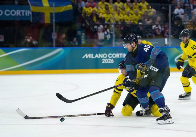 (260213) -- MILAN, Feb. 13, 2026 (Xinhua) -- Joel Armia (front) of Finland vies with Gustav Forsling of Sweden during the ice hockey men's preliminary round group B match between Finland and Sweden at the Milan-Cortina 2026 Olympic Winter Games in Milan, Italy, Feb. 13, 2026. (Xinhua/Tao Xiyi)