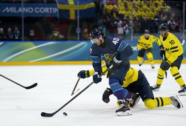 (260213) -- MILAN, Feb. 13, 2026 (Xinhua) -- Joel Armia (front) of Finland competes during the ice hockey men's preliminary round group B match between Finland and Sweden at the Milan-Cortina 2026 Olympic Winter Games in Milan, Italy, Feb. 13, 2026. (Xinhua/Tao Xiyi)