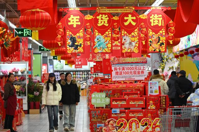 (260213) -- BEIJING, Feb. 13, 2026 (Xinhua) -- People shop for goods needed for the Chinese New Year celebrations at a market in Kaifeng, central China's Henan Province, Feb. 11, 2026. Markets across the country are bustling nowadays as people flock there to stock up on goods in preparation for the upcoming Spring Festival, or the Chinese New Year. (Photo by Li Junsheng/Xinhua)