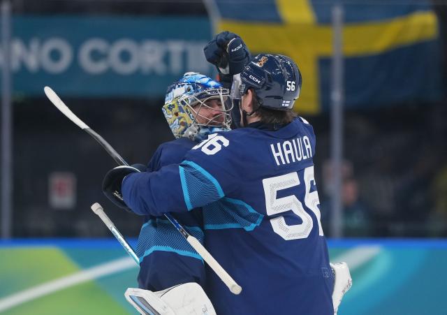 (260213) -- MILAN, Feb. 13, 2026 (Xinhua) -- Erik Haula (R) of Finland celebrates with teammate Juuse Saros during the ice hockey men's preliminary round group B match between Finland and Sweden at the Milan-Cortina 2026 Olympic Winter Games in Milan, Italy, Feb. 13, 2026. (Xinhua/Tao Xiyi)
