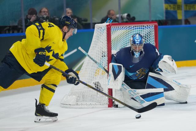 (260213) -- MILAN, Feb. 13, 2026 (Xinhua) -- Joel Eriksson Ek (L) of Sweden prepares to shoot during the ice hockey men's preliminary round group B match between Finland and Sweden at the Milan-Cortina 2026 Olympic Winter Games in Milan, Italy, Feb. 13, 2026. (Xinhua/Tao Xiyi)
