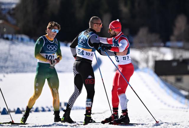 (260213) -- TESERO, Feb. 13, 2026 (Xinhua) -- Matthew Smith (L) of South Africa, Allan Corona (C) of Mexico and Samer Tawk of Lebanon greet each other after finishing during the Cross-Country Skiing Men's 10km Interval Start Free at the Milano Cortina 2026 Olympic Winter Games in Tesero, Italy, Feb. 13, 2026. (Xinhua/He Canling)