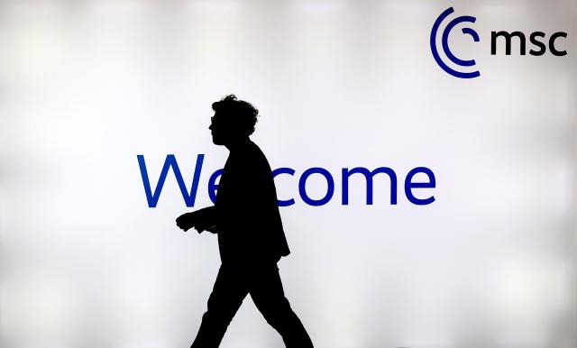 (260213) -- MUNICH, Feb. 13, 2026 (Xinhua) -- A man walks past a screen at the media center for the 62nd Munich Security Conference (MSC) in Munich, Germany, Feb. 13, 2026. The 62nd Munich Security Conference kicked off on Friday against the backdrop of deepening transatlantic tensions and an increasingly volatile geopolitical landscape. (Xinhua/Li Ying)