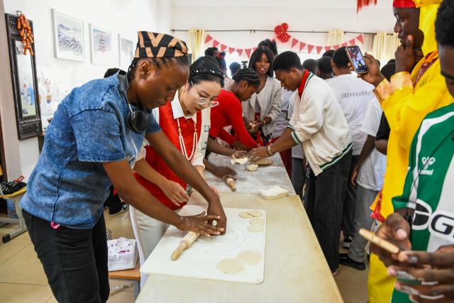 (260213) -- SOA, Feb. 13, 2026 (Xinhua) -- Teachers and students of the Confucius Institute of the University of Yaounde II make dumplings in Soa, Cameroon, Feb. 13, 2026. (Xinhua/Kepseu)