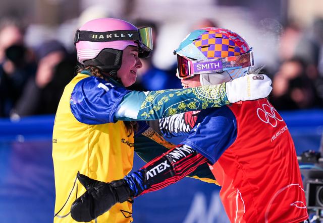 (260213) -- LIVIGNO, Feb. 13, 2026 (Xinhua) -- Josie Baff (L) of Australia hugs Eva Adamczykova of the Czech Republic after the women's snowboard cross big final at the Milan-Cortina 2026 Olympic Winter Games in Livigno, Italy, Feb. 13, 2026. (Xinhua/Wu Huiwo)
