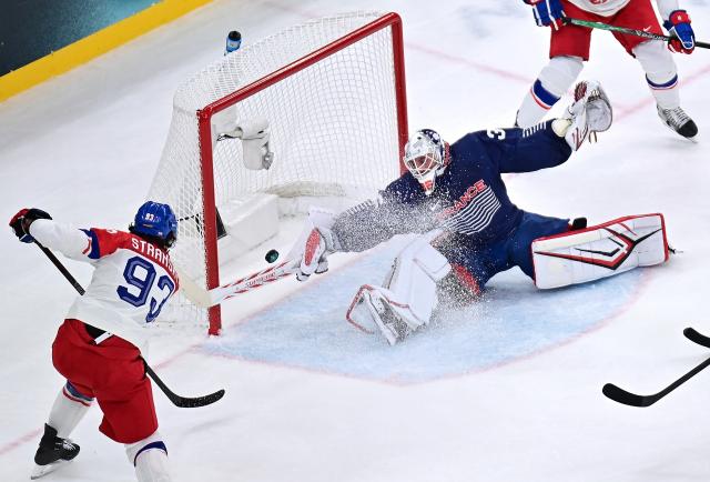 (260213) -- MILAN, Feb. 13, 2026 (Xinhua) -- Matej Stransky (L) of the Czech Republic shoots during the ice hockey men's preliminary round group A match between France and the Czech Republic at the Milan-Cortina 2026 Olympic Winter Games in Milan, Italy, Feb. 13, 2026. (Xinhua/Tao Xiyi)