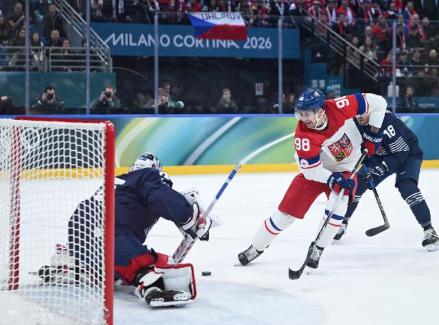 (260213) -- MILAN, Feb. 13, 2026 (Xinhua) -- Martin Necas (R) of the Czech Republic shoots during the ice hockey men's preliminary round group A match between France and the Czech Republic at the Milan-Cortina 2026 Olympic Winter Games in Milan, Italy, Feb. 13, 2026. (Xinhua/Zhang Haofu)