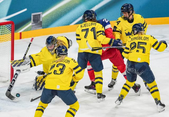 (260213) -- MILAN, Feb. 13, 2026 (Xinhua) -- Ebba Svensson Traff (1st L) of Sweden saves a goal during the ice hockey women's play-offs quarterfinals match between the Czech Republic and Sweden at the Milan-Cortina 2026 Olympic Winter Games in Milan, Italy, Feb. 13, 2026. (Xinhua/Sun Fei)
