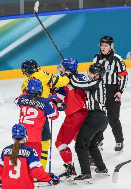(260213) -- MILAN, Feb. 13, 2026 (Xinhua) -- Hanna Olsson (L, above) of Sweden and Kristyna Kaltounkova of the Czech Republic fight during the ice hockey women's play-offs quarterfinals match between the Czech Republic and Sweden at the Milan-Cortina 2026 Olympic Winter Games in Milan, Italy, Feb. 13, 2026. (Xinhua/Sun Fei)