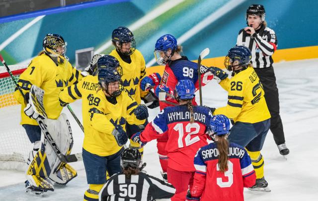 (260213) -- MILAN, Feb. 13, 2026 (Xinhua) -- Hanna Olsson (2nd R) of Sweden and Kristyna Kaltounkova of the Czech Republic fight during the ice hockey women's play-offs quarterfinals match between the Czech Republic and Sweden at the Milan-Cortina 2026 Olympic Winter Games in Milan, Italy, Feb. 13, 2026. (Xinhua/Sun Fei)