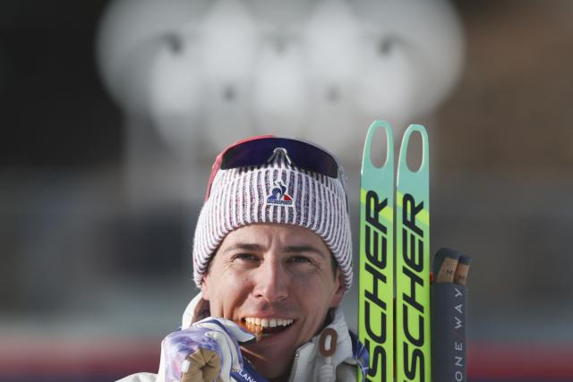 (260213) -- ANTERSELVA, Feb. 13, 2026 (Xinhua) -- Gold medalist Quentin Fillon Maillet of France bites his medal during the awarding ceremony of the biathlon men's 10km sprint event at the Milan-Cortina 2026 Olympic Winter Games in Anterselva, Italy, Feb. 13, 2026. (Xinhua/Zhang Tao)