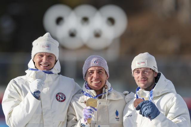 (260213) -- ANTERSELVA, Feb. 13, 2026 (Xinhua) -- Gold medalist Quentin Fillon Maillet (C) of France, silver medalist Vetle Sjaastad Christiansen (L) of Norway, and bronze medalist Sturla Holm Laegreid of Norway pose for photos during the awarding ceremony of the biathlon men's 10km sprint event at the Milan-Cortina 2026 Olympic Winter Games in Anterselva, Italy, Feb. 13, 2026. (Xinhua/Zhang Tao)