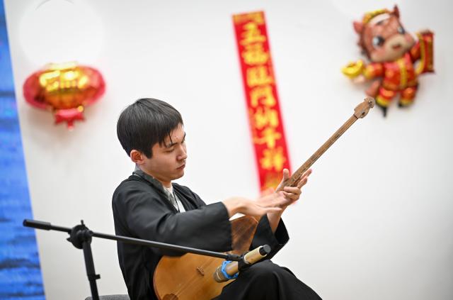 (260213) -- ALMATY, Feb. 13, 2026 (Xinhua) -- A student from the Confucius Institute at Al-Farabi Kazakh National University plays the dombra during a Chinese New Year cultural event in Almaty, Kazakhstan, Feb. 13, 2026. (Xinhua/Li Renzi)