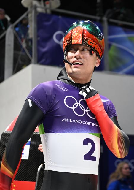 (260213) -- CORTINA D'AMPEZZO, Feb. 13, 2026 (Xinhua) -- Yin Zheng of China reacts after the skeleton men competition at the Milan-Cortina 2026 Olympic Winter Games in Cortina, Italy, Feb. 13, 2026. (Xinhua/Lian Yi)