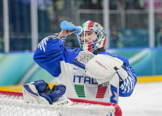 (260214) -- MILAN, Feb. 14, 2026 (Xinhua) -- Gabriella Durante, goalkeeper of Italy cools herself with water during the ice hockey women's play-offs quarterfinal match between the United States and Italy at the Milan-Cortina 2026 Olympic Winter Games in Milan, Italy, Feb. 13, 2026. (Xinhua/Sun Fei)