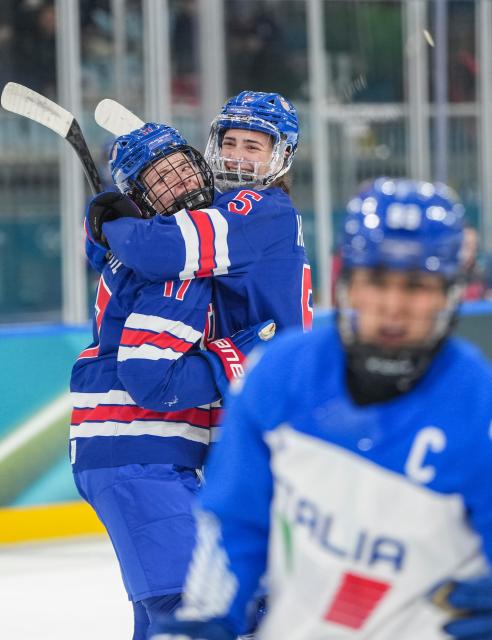 (260214) -- MILAN, Feb. 14, 2026 (Xinhua) -- Britta Curl (L) of the United States celebrates a goal with her teammate during the ice hockey women's play-offs quarterfinal match between the United States and Italy at the Milan-Cortina 2026 Olympic Winter Games in Milan, Italy, Feb. 13, 2026. (Xinhua/Sun Fei)