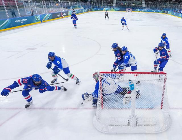 (260214) -- MILAN, Feb. 14, 2026 (Xinhua) -- Tessa Janecke (1st L) of the United States shoots during the ice hockey women's play-offs quarterfinal match between the United States and Italy at the Milan-Cortina 2026 Olympic Winter Games in Milan, Italy, Feb. 13, 2026. (Xinhua/Sun Fei)
