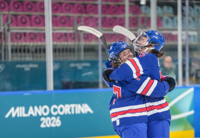 (260214) -- MILAN, Feb. 14, 2026 (Xinhua) -- Britta Curl (L) of the United States celebrates a goal with her teammate during the ice hockey women's play-offs quarterfinal match between the United States and Italy at the Milan-Cortina 2026 Olympic Winter Games in Milan, Italy, Feb. 13, 2026. (Xinhua/Sun Fei)