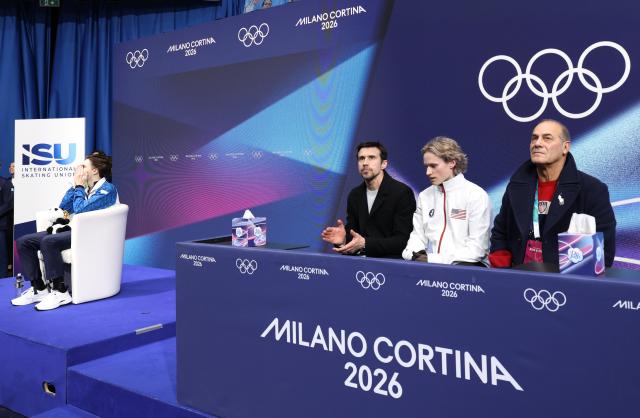 (260214) -- MILAN, Feb. 14, 2026 (Xinhua) -- Ilia Malinin (2nd R) of the United States as he waits for the score during the men's single skating free skating of figure skating event at the Milan-Cortina 2026 Olympic Winter Games in Milan, Italy, Feb. 13, 2026. (Xinhua/Li Ming)