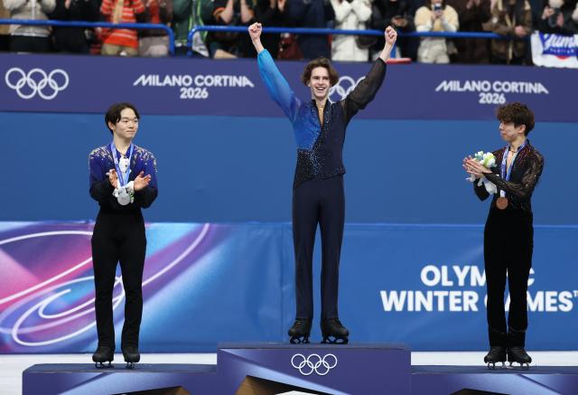 (260214) -- MILAN, Feb. 14, 2026 (Xinhua) -- Silver medalist Kagiyama Yuma of Japan, gold medalist Mikhail Shaidorov of Kazakhstan and bronze medalist Sato Shun of Japan (L to R) are seen on the podium after the men's single skating free skating of figure skating event at the Milan-Cortina 2026 Olympic Winter Games in Milan, Italy, Feb. 13, 2026. (Xinhua/Li Ming)