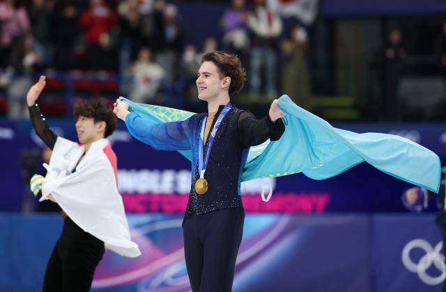 (260214) -- MILAN, Feb. 14, 2026 (Xinhua) -- Mikhail Shaidorov (R) of Kazakhstan celebrates after winning the men's single skating free skating of figure skating event at the Milan-Cortina 2026 Olympic Winter Games in Milan, Italy, Feb. 13, 2026. (Xinhua/Li Ming)