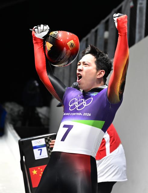 (260214) -- CORTINA D'AMPEZZO, Feb. 14, 2026 (Xinhua) -- China's Chen Wenhao reacts after his competition during the skeleton men competition heat 4 at the Milan-Cortina 2026 Olympic Winter Games in Cortina, Italy, Feb. 13, 2026. (Xinhua/Lian Yi)