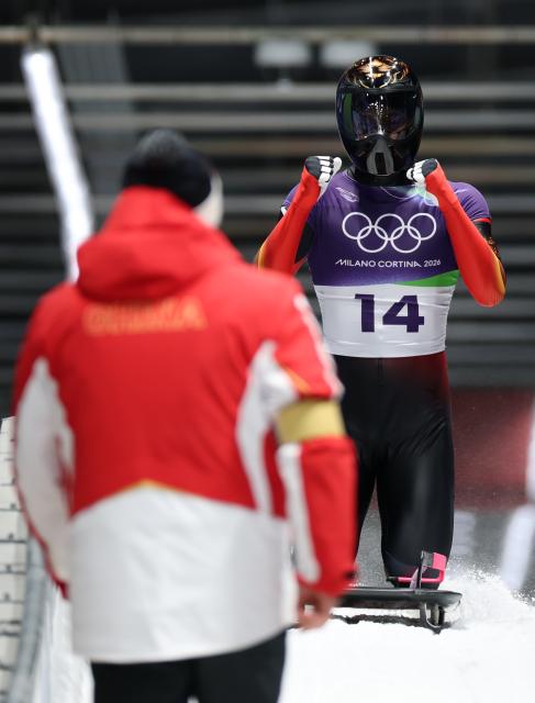 (260214) -- CORTINA D'AMPEZZO, Feb. 14, 2026 (Xinhua) -- China's Lin Qinwei reacts after his competition during the skeleton men competition heat 4 at the Milan-Cortina 2026 Olympic Winter Games in Cortina, Italy, Feb. 13, 2026. (Xinhua/Ding Xu)