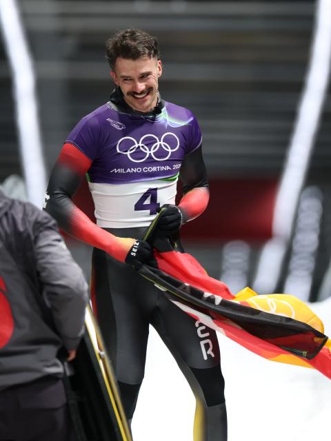 (260214) -- CORTINA D'AMPEZZO, Feb. 14, 2026 (Xinhua) -- Axel Jungk of Germany reacts after his competition during the skeleton men competition heat 4 at the Milan-Cortina 2026 Olympic Winter Games in Cortina, Italy, Feb. 13, 2026. (Xinhua/Ding Xu)