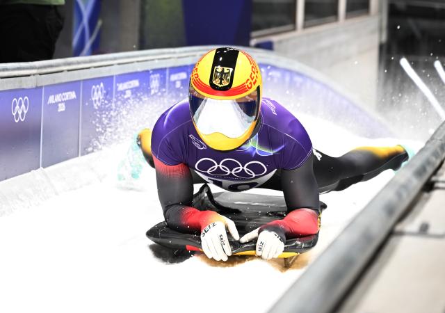 (260214) -- CORTINA D'AMPEZZO, Feb. 14, 2026 (Xinhua) -- Christopher Grotheer of Germany reacts after crossing the finish line during the skeleton men competition heat 4 at the Milan-Cortina 2026 Olympic Winter Games in Cortina, Italy, Feb. 13, 2026. (Xinhua/Lian Yi)