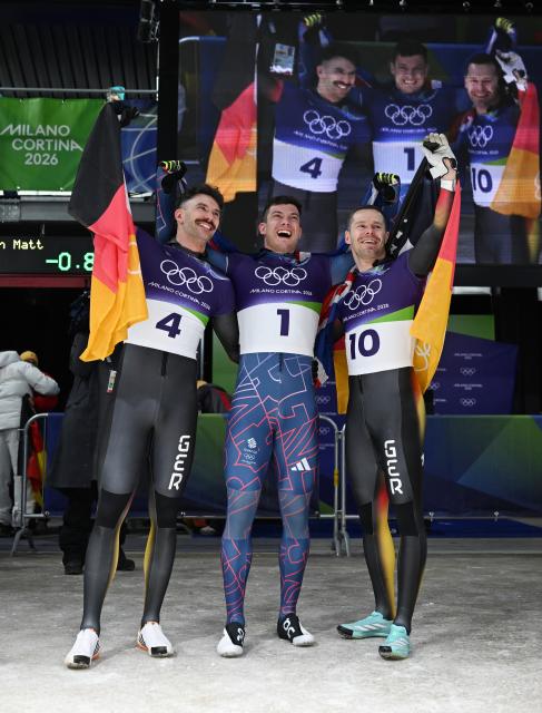 (260214) -- CORTINA D'AMPEZZO, Feb. 14, 2026 (Xinhua) -- Gold medalist Matt Weston (C) of Britain, silver medalist Axel Jungk (L) of Germany and bronze medalist Christopher Grotheer of Germnay celebrate after the skeleton men competition heat 4 at the Milan-Cortina 2026 Olympic Winter Games in Cortina, Italy, Feb. 13, 2026. (Xinhua/Lian Yi)