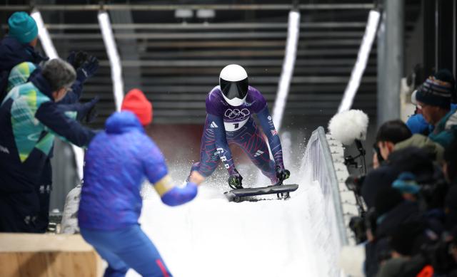 (260214) -- CORTINA D'AMPEZZO, Feb. 14, 2026 (Xinhua) -- Matt Weston of Britain reacts after crossing the finish line during the skeleton men competition heat 4 at the Milan-Cortina 2026 Olympic Winter Games in Cortina, Italy, Feb. 13, 2026. (Xinhua/Ding Xu)