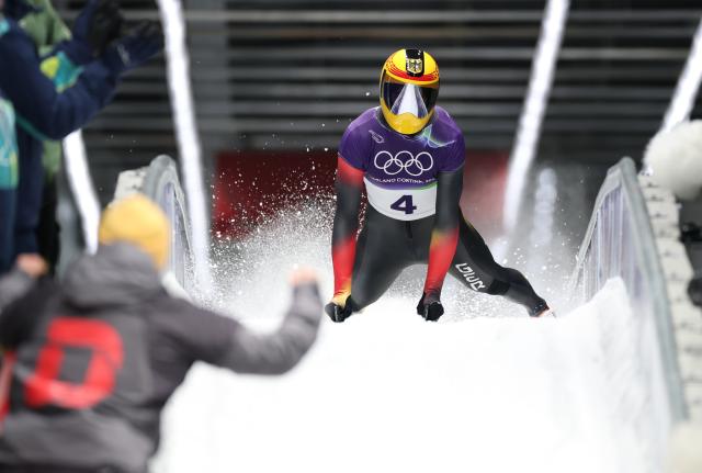 (260214) -- CORTINA D'AMPEZZO, Feb. 14, 2026 (Xinhua) -- Axel Jungk of Germany reacts after crossing the finish line during the skeleton men competition heat 4 at the Milan-Cortina 2026 Olympic Winter Games in Cortina, Italy, Feb. 13, 2026. (Xinhua/Ding Xu)