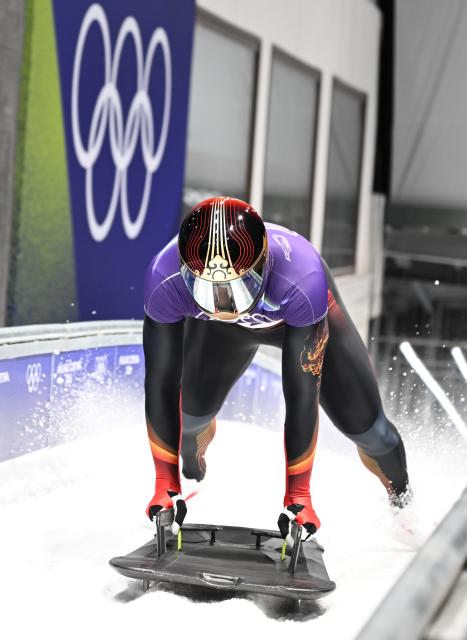 (260214) -- CORTINA D'AMPEZZO, Feb. 14, 2026 (Xinhua) -- China's Chen Wenhao reacts after crossing the finish line during the skeleton men competition heat 4 at the Milan-Cortina 2026 Olympic Winter Games in Cortina, Italy, Feb. 13, 2026. (Xinhua/Lian Yi)