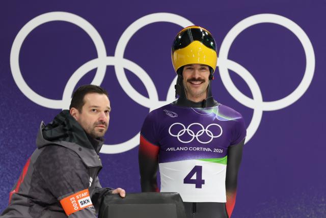 (260214) -- CORTINA D'AMPEZZO, Feb. 14, 2026 (Xinhua) -- Axel Jungk (R) of Germany gets ready to compete during the skeleton men competition heat 3 at the Milan-Cortina 2026 Olympic Winter Games in Cortina, Italy, Feb. 13, 2026. (Xinhua/Ding Xu)