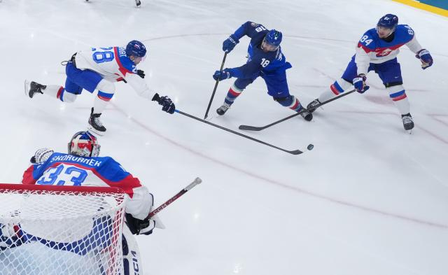 (260214) -- MILAN, Feb. 14, 2026 (Xinhua) -- Saracino Nicholas (C) of Italy shoots during the ice hockey men's preliminary round group B match between Slovakia and Italy of the Milan-Cortina 2026 Olympic Winter Games in Milan, Italy, Feb. 13, 2026. (Wang Kaiyan/Pool via Xinhua)