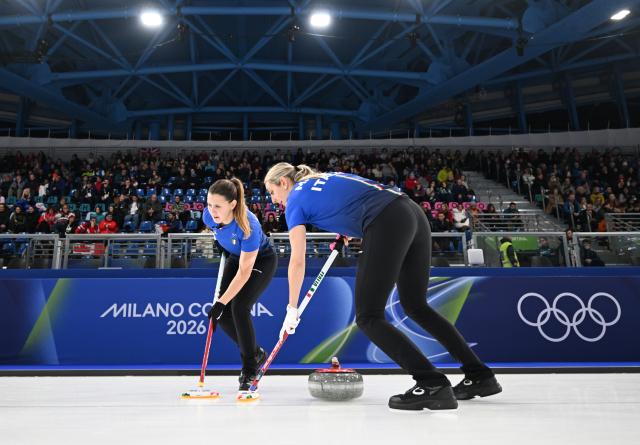 (260214) -- CORTINA D'AMPEZZO, Feb. 14, 2026 (Xinhua) -- Elena Mathis (R) and Marta Lo Deserto of Italy competes during the curling women round robin session 4 match between China and Italy at the 2026 Milan-Cortina Winter Olympics in Cortina, Italy, Feb. 14, 2026. (Xinhua/Lian Yi)