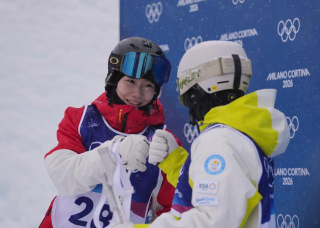 (260214) -- LIVIGNO, Feb. 14, 2026 (Xinhua) -- Yang Ya (L) of China greets Anastassiya Gorodko of Kazakhstan after competing during the freestyle skiing women's dual moguls 1/16 finals at the Milan-Cortina 2026 Olympic Winter Games in Livigno, Italy, Feb. 14, 2026. (Xinhua/Hu Chao)