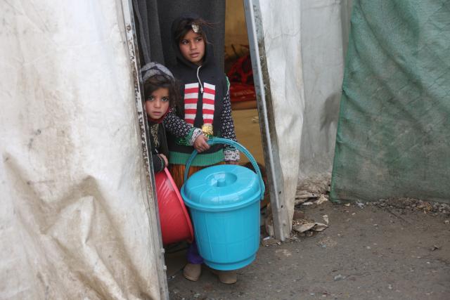(260214) -- KABUL, Feb. 14, 2026 (Xinhua) -- Afghan children are seen at a makeshift refugee camp in Kabul, Afghanistan, Feb. 14, 2026. Nearly 150,000 Afghans have returned from Iran and Pakistan so far this year, the United Nations High Commissioner for Refugees (UNHCR) said on Friday, adding to an already unprecedented wave of returns that is deepening a humanitarian crisis in the country amid severe winter conditions. (Photo by Saifurahman Safi/Xinhua)
